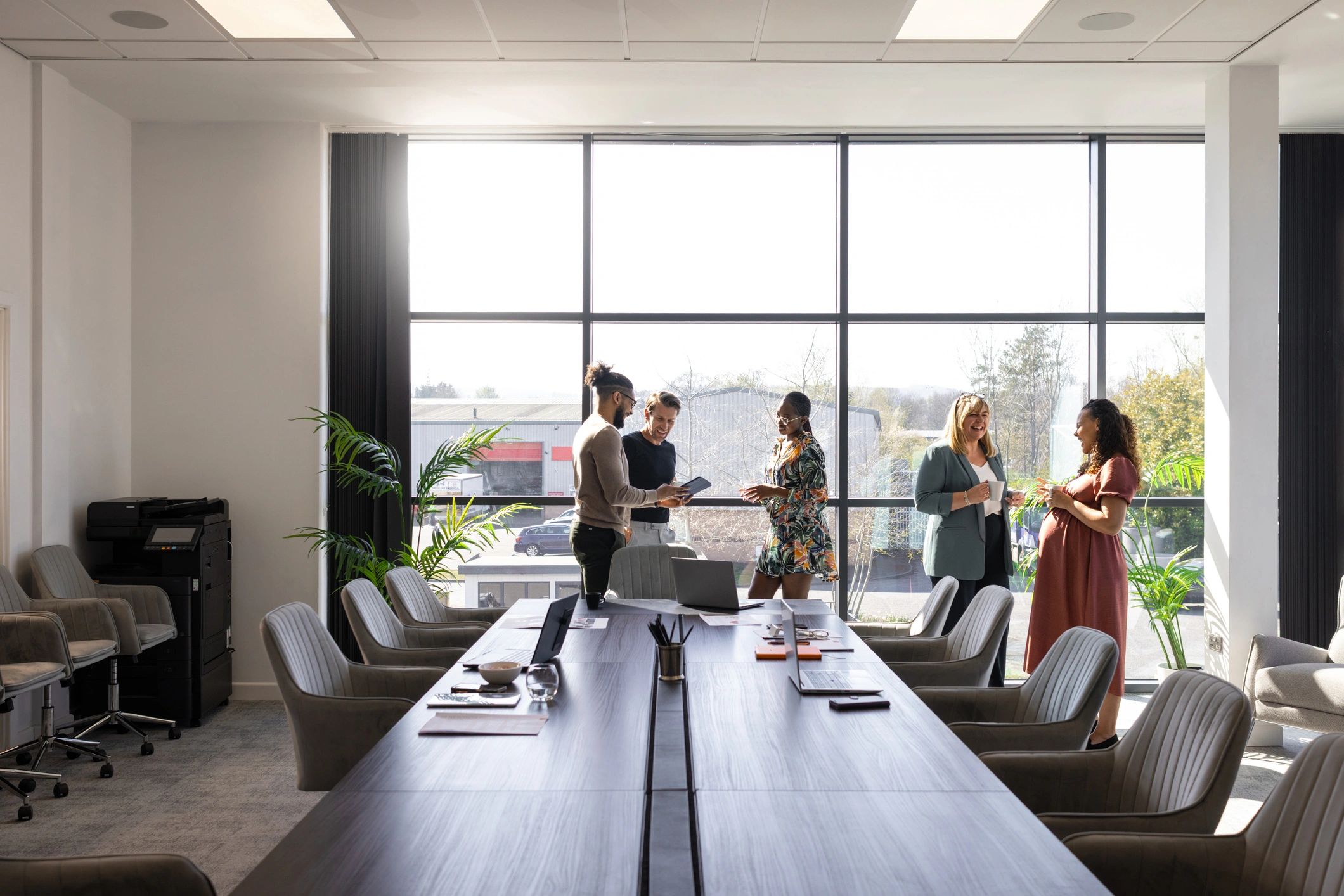 Business editorial team collaborating in a modern meeting room